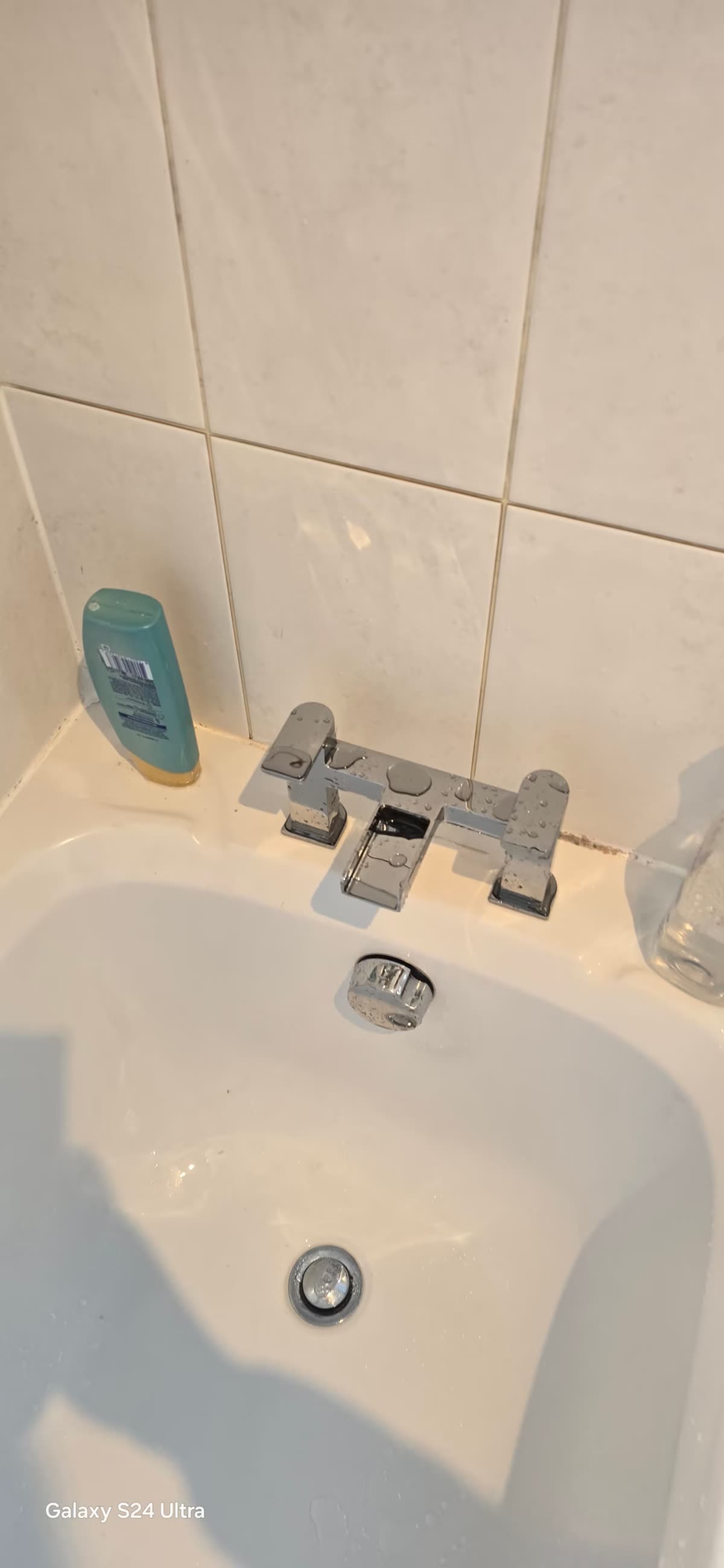 Toilet and basin unit installed alongside a corner shower enclosure