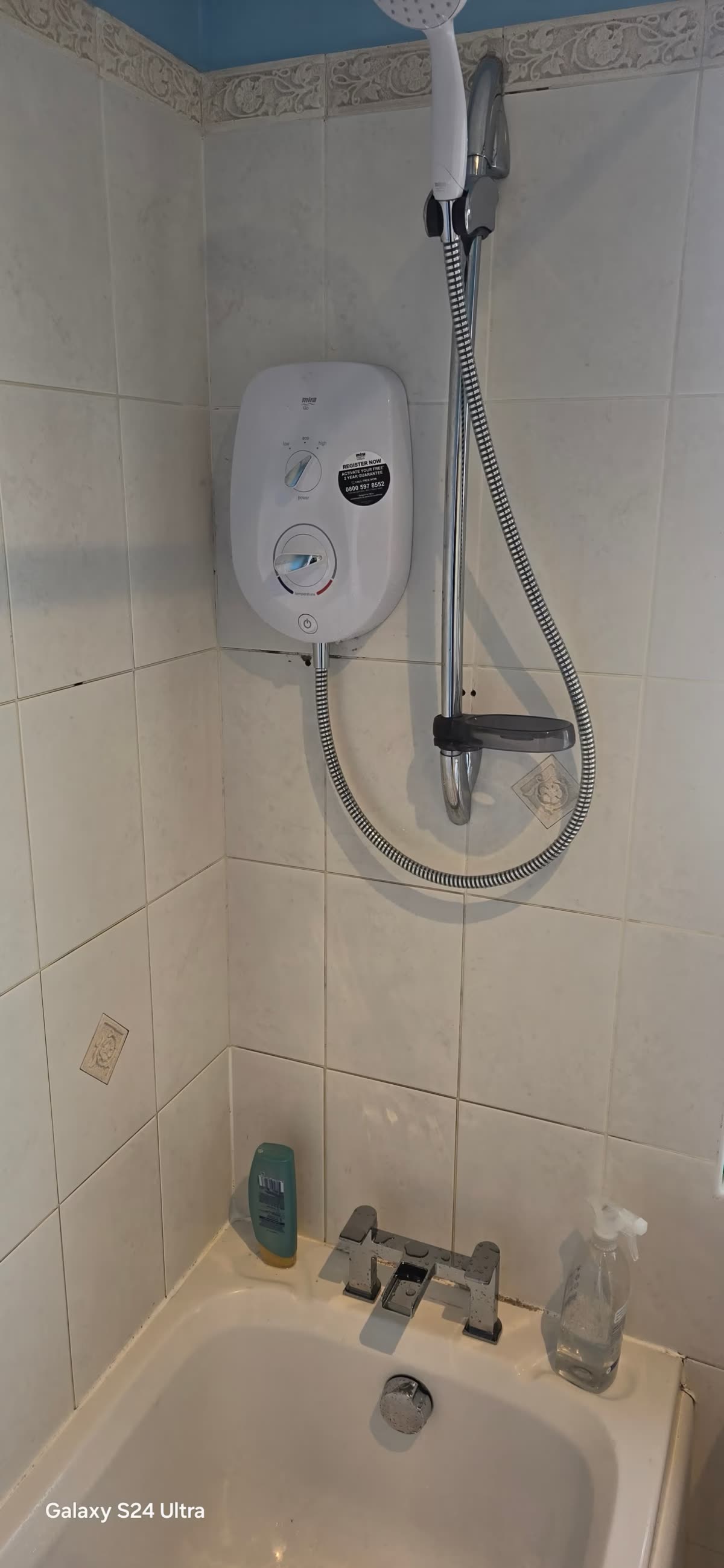 Electric shower installation with new pipework above a shower tray